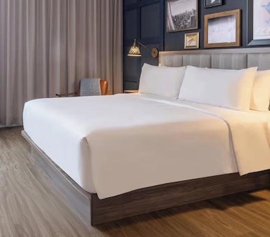 Hotel guest room bed styled to brand standard